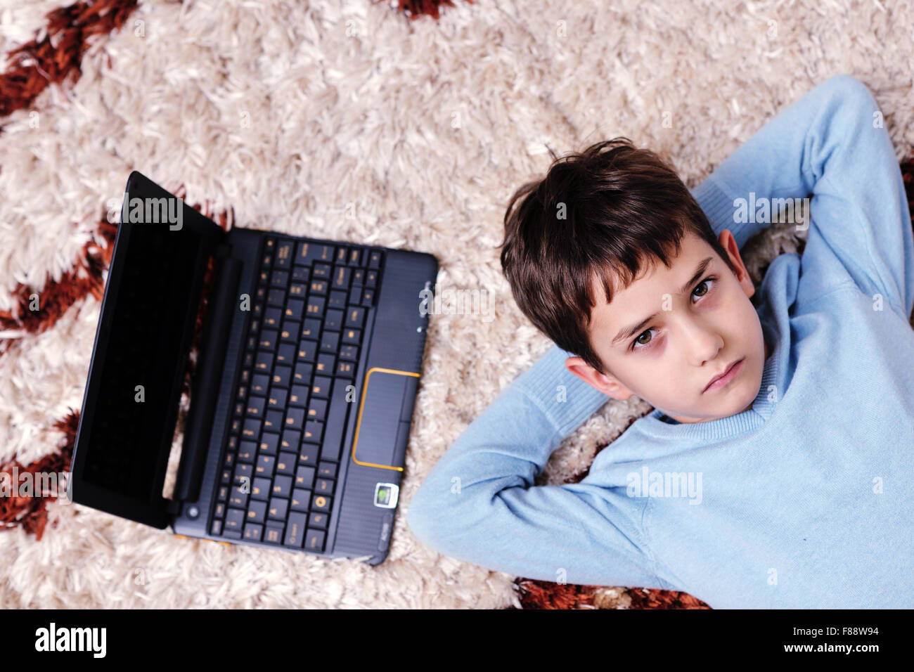 happy child boy relax at home with laptop computer in background Stock ...