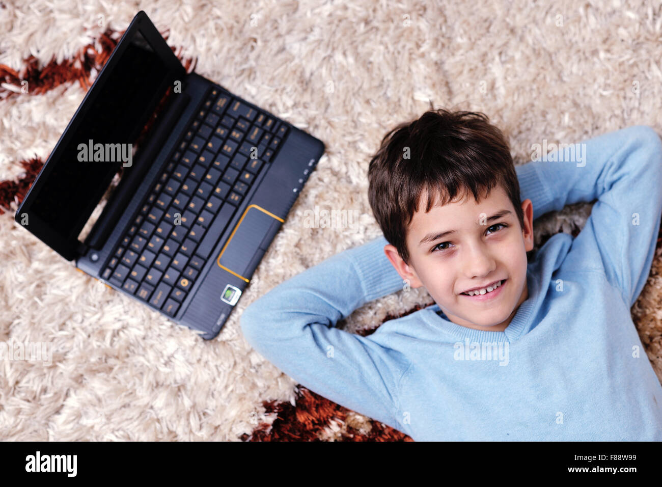 happy child boy relax at home with laptop computer in background Stock ...