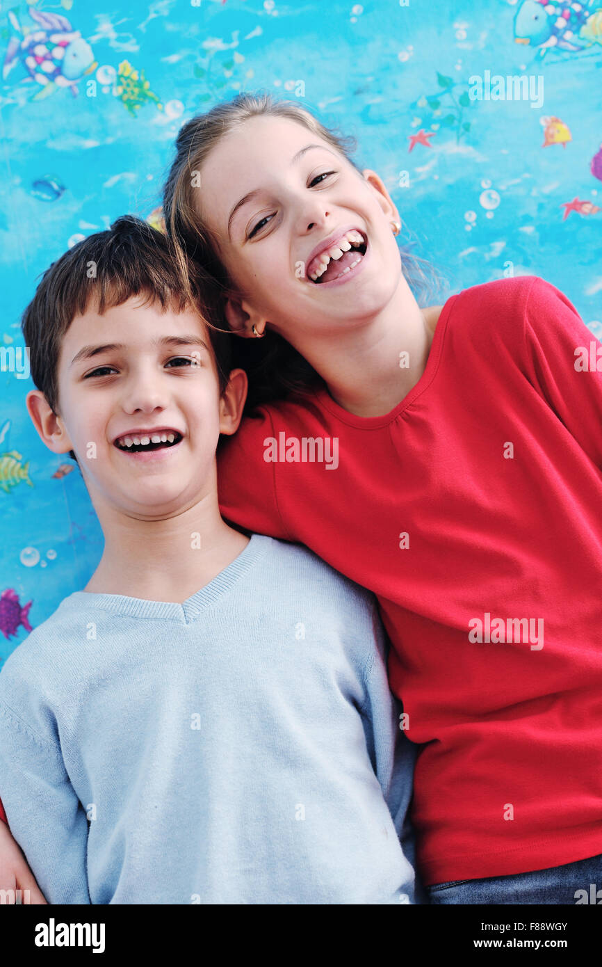 happy child kids portrait at home brother and sister hug and have fun and joy Stock Photo