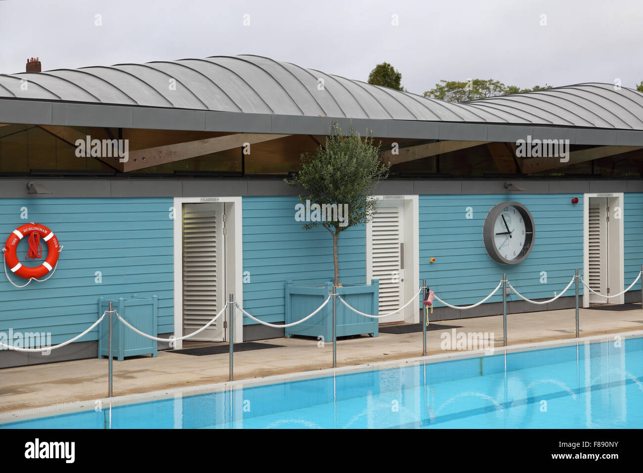 A changing room block at a new open air swimming pool in London, UK. Shows a distinctive wood and zinc curved roof Stock Photo