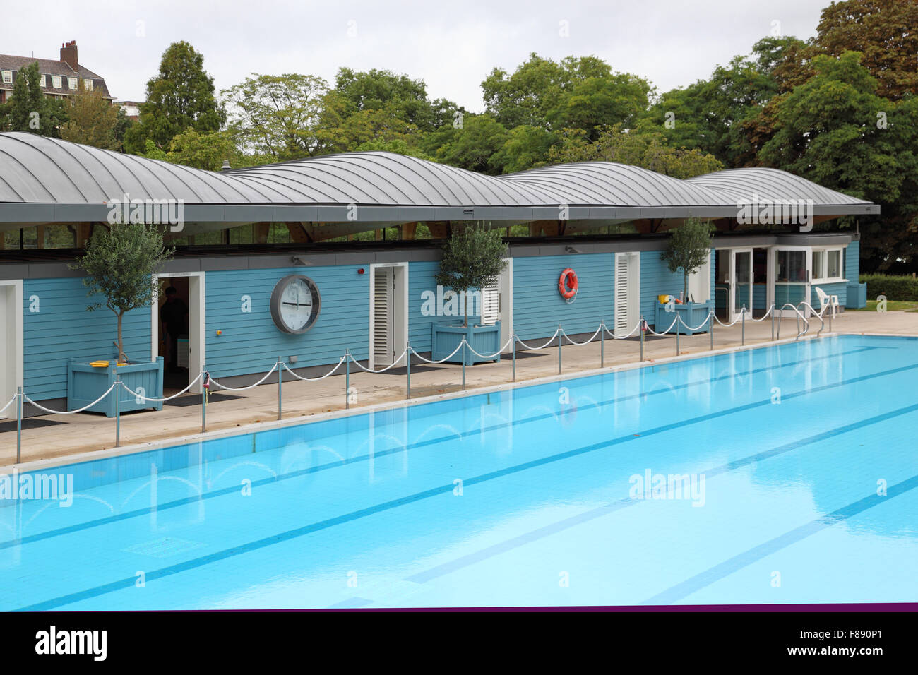 The open air swimming pool close to the River Thames at London's Hurlingham club. Shows new changing room block. Stock Photo