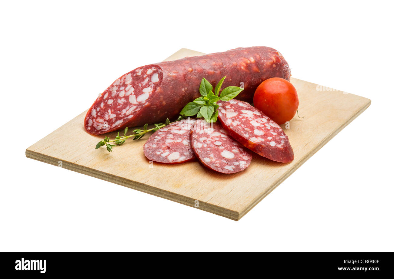 Salami sausages sliced with basil and tomato Stock Photo - Alamy