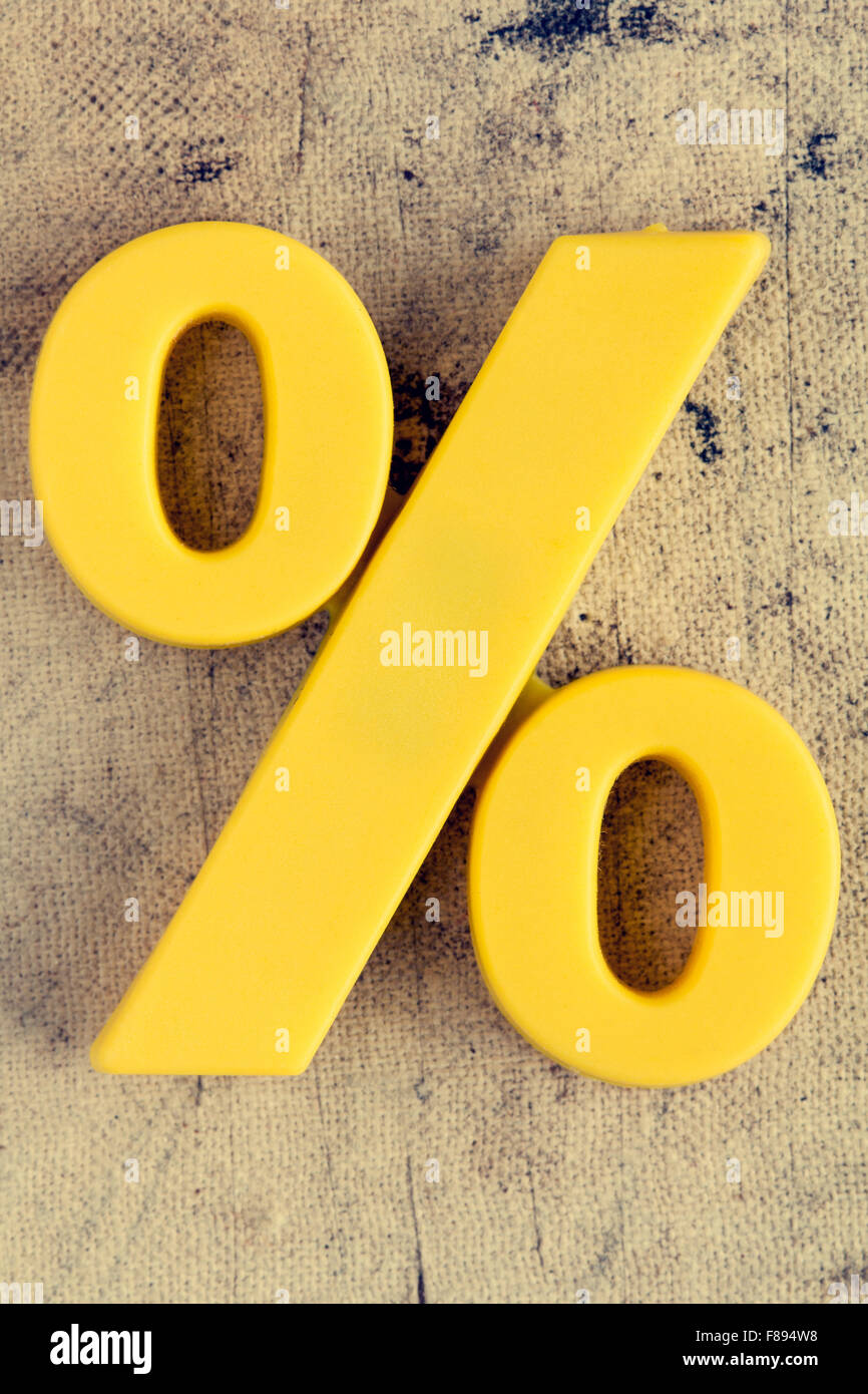 Yellow plastic percentage sign on grunge background Stock Photo