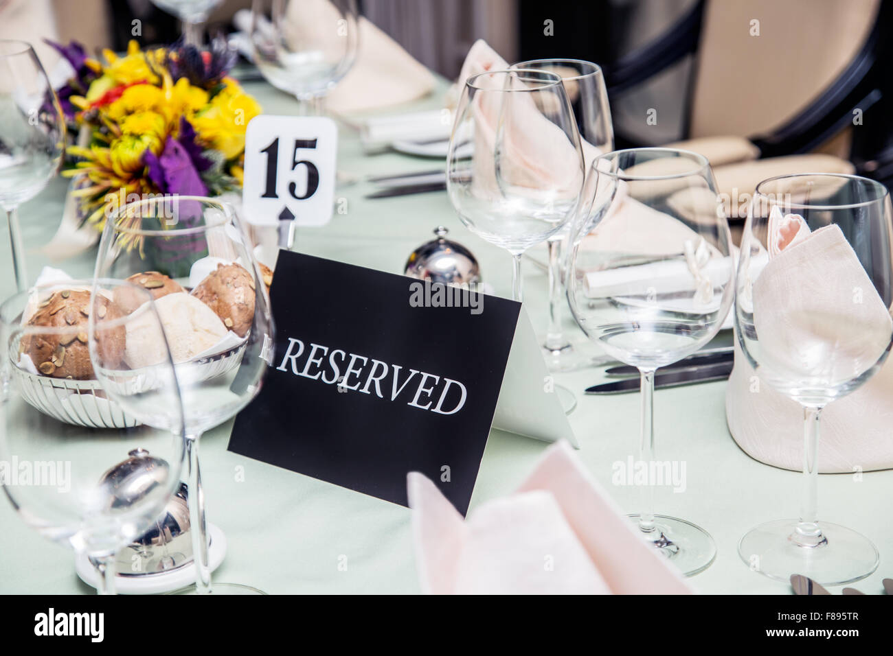 Festival dinner setting and 'Reserved' sign. Stock Photo