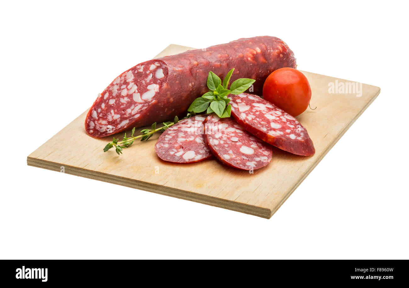 Salami sausages sliced with basil and tomato Stock Photo - Alamy