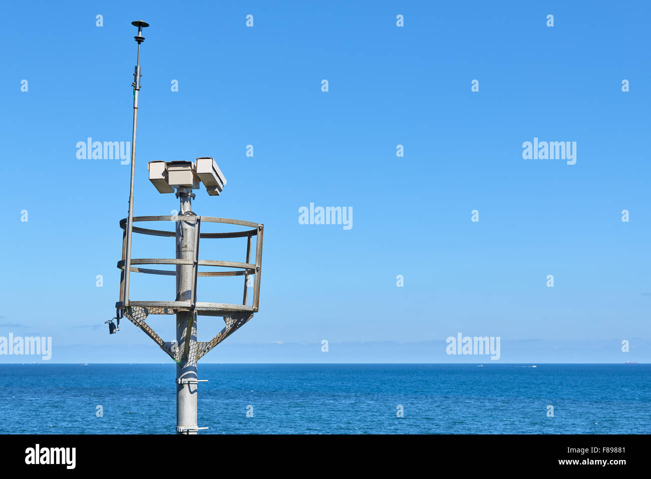 surveillance security camera and lightning rod on the background of sea Stock Photo