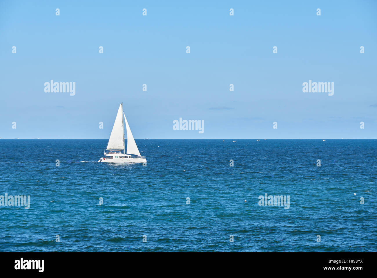 white luxury yacht sailing at sea on a background of horizon Stock Photo