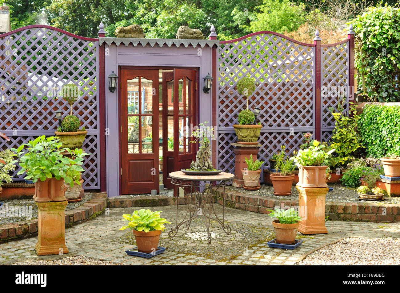 Trellis and fake doorway with mirror in Garden Stock Photo - Alamy