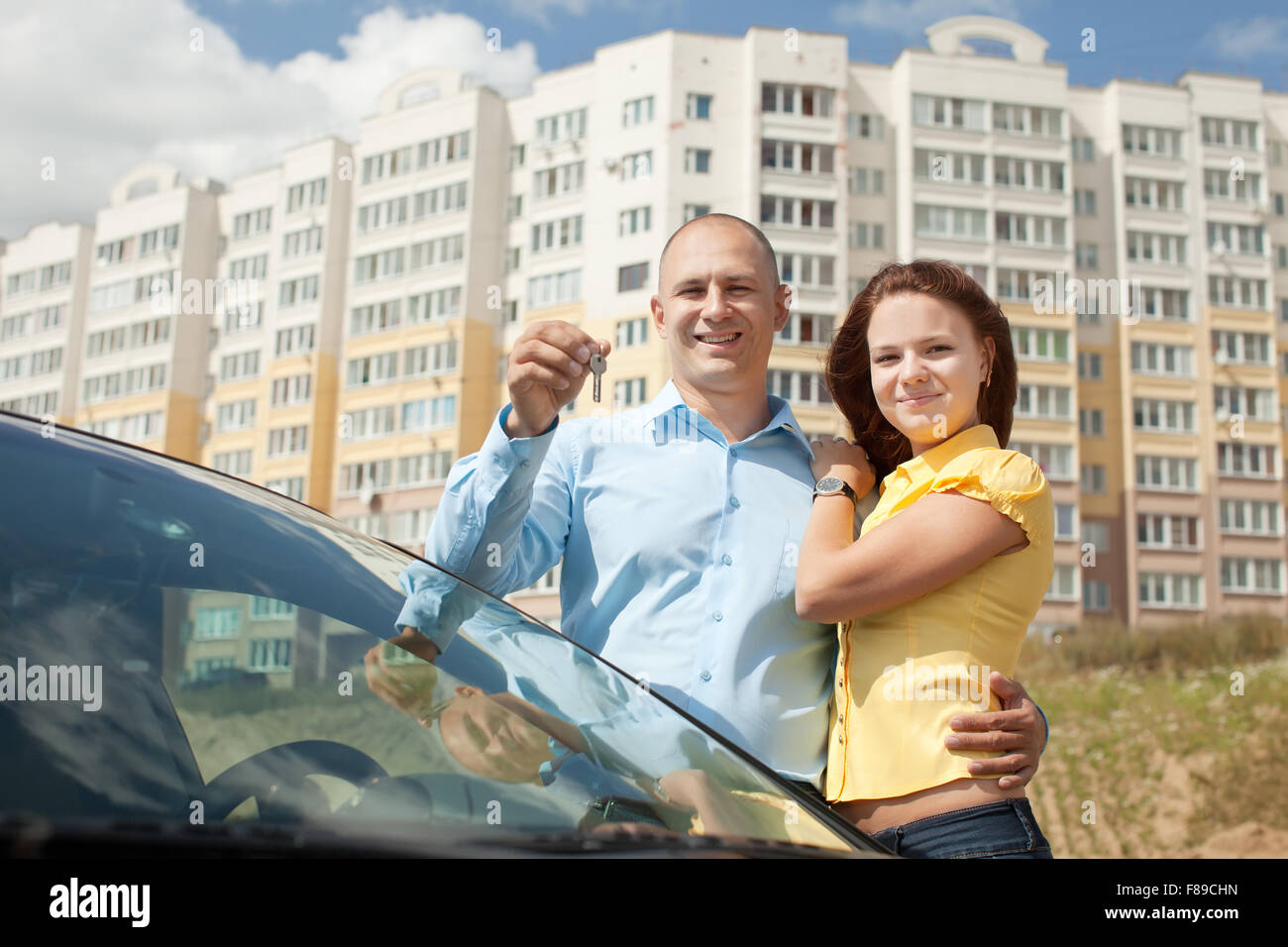 happy young family in front of new home Stock Photo - Alamy