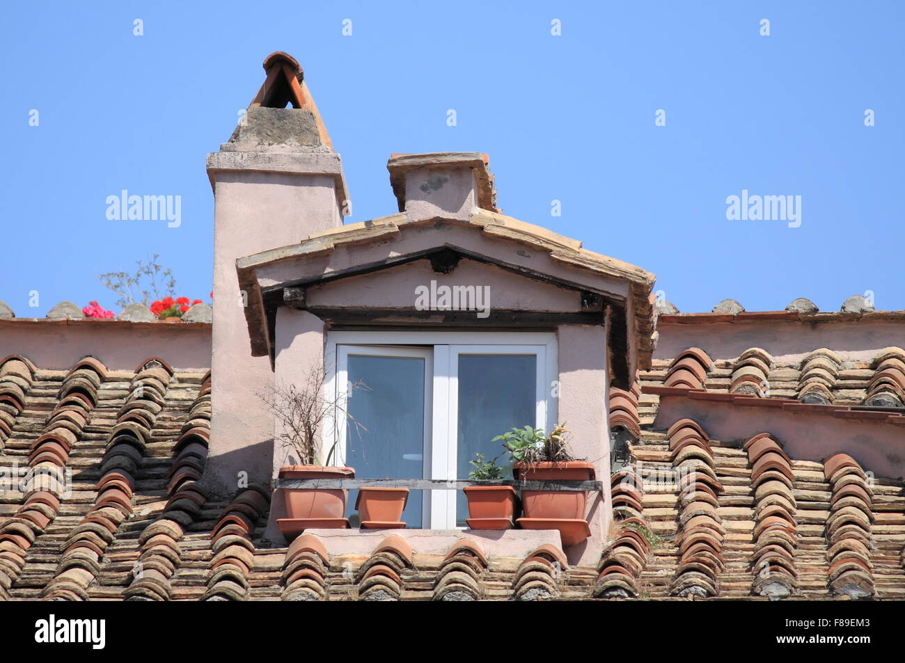 Mansard window in a old style roof Stock Photo