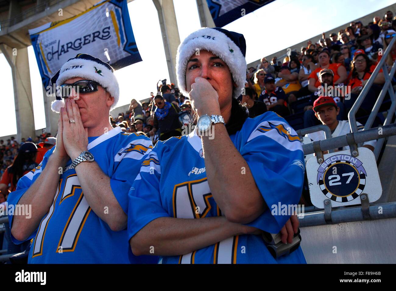 San Diego, CA, USA. 6th Dec, 2015. SAN DIEGO The San Diego Chargers took on the Denver Broncos in their next-to-last-home game at Qualcomm Stadium. As is usual with the Chargers, there were at least as many Broncos fans going to the game.|Patrick Vaughan, and wife Laura Vaughan, react with sympathy as they watch injured Charger '.Dontrelle Inman being carted off the field with a neck injury that required a neck and back brace.| John Gastaldo/San Diego Union-Tribune © John Gastaldo/U-T San Diego/ZUMA Wire/Alamy Live News Stock Photo