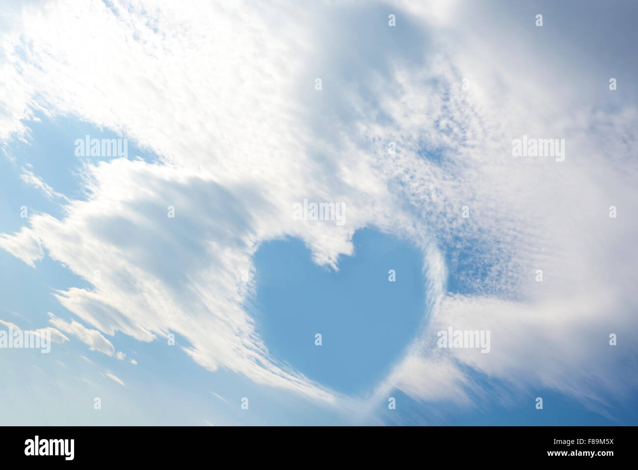 blue sky love heart among white fluffy clouds Stock Photo - Alamy