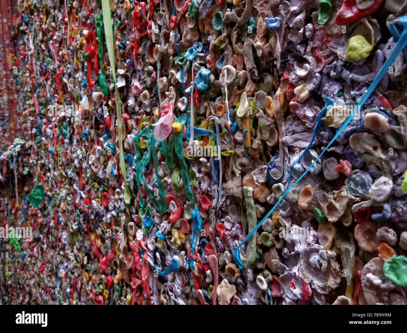 The Pike Place Market Theater Gum Wall in Seattle, Washington is covered in used chewing gum. Stock Photo