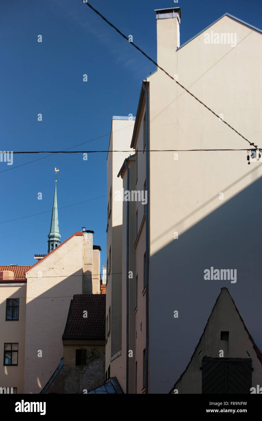 The geometry of the facades of old houses in the old city on the background of blue sky in Riga on a sunny summer day Stock Photo