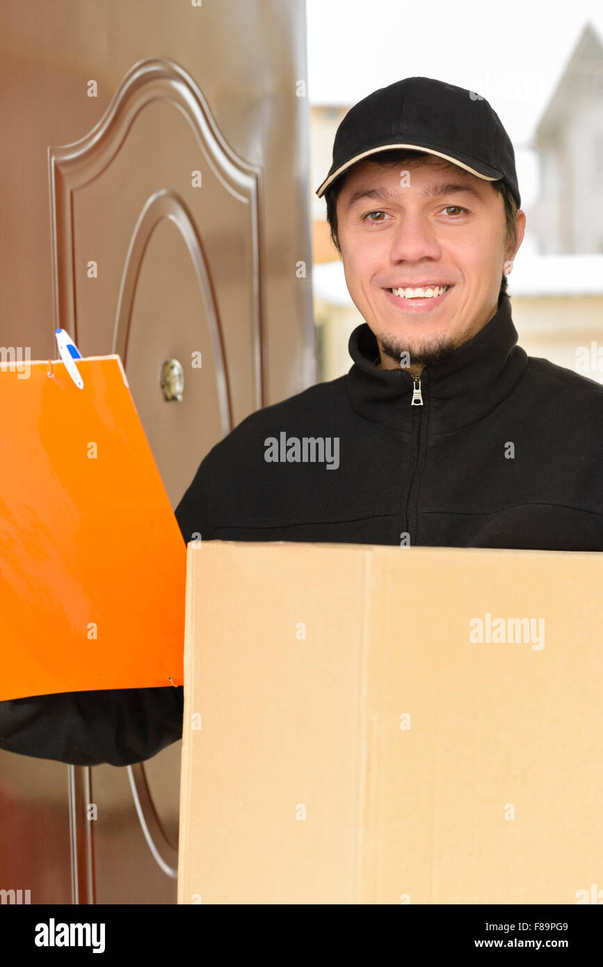 Courier Delivering a Package to entrance Stock Photo