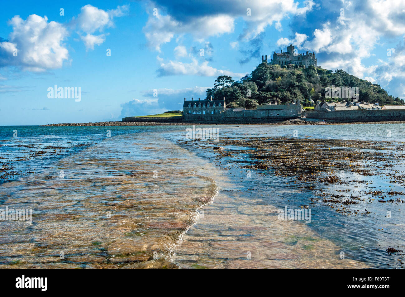 St Michaels Mount off the coast of Cornwall near Marazion with the tide creeping up over the causeway Stock Photo
