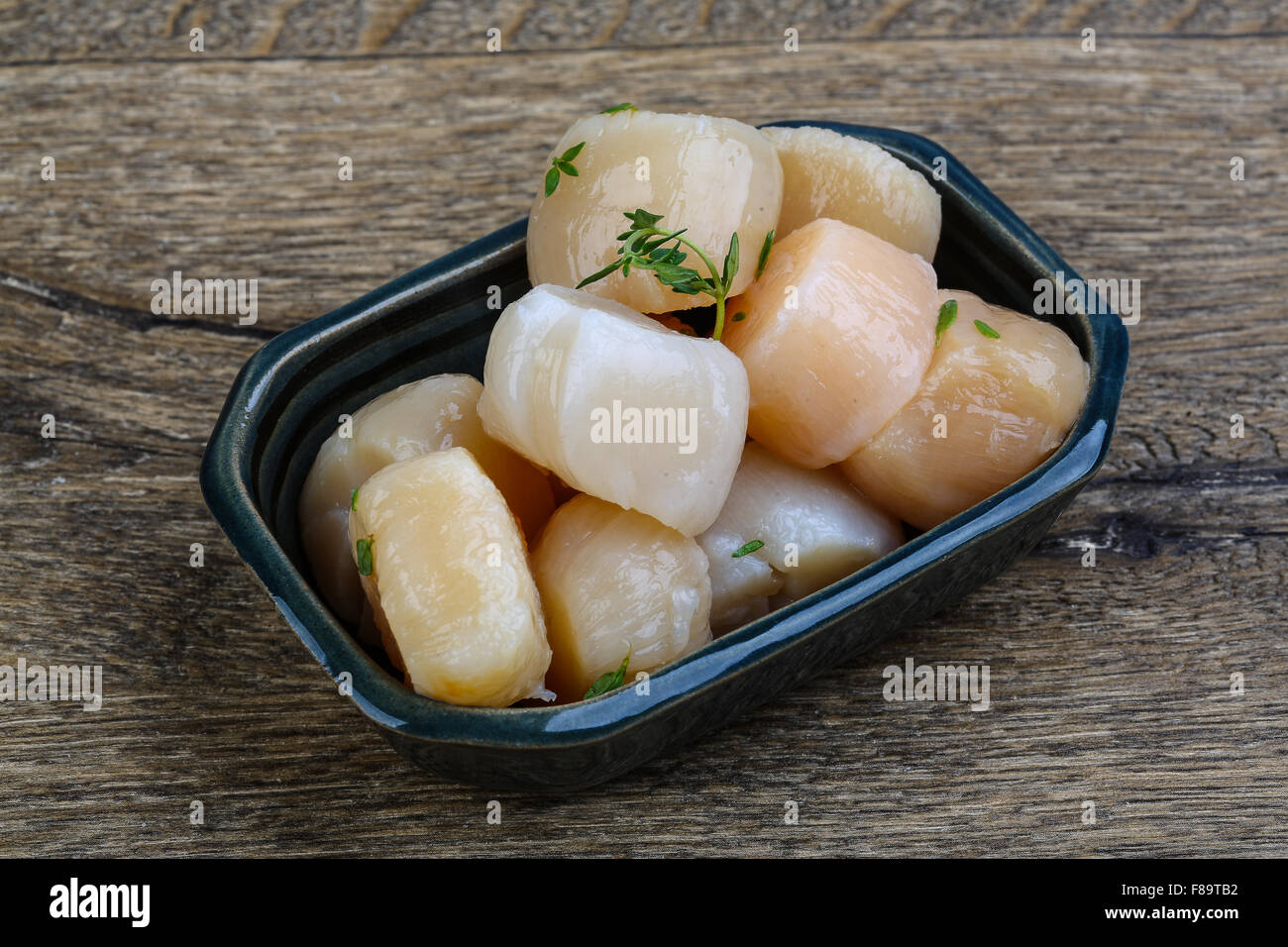 Raw scallops with thyme ready for cooking Stock Photo Alamy