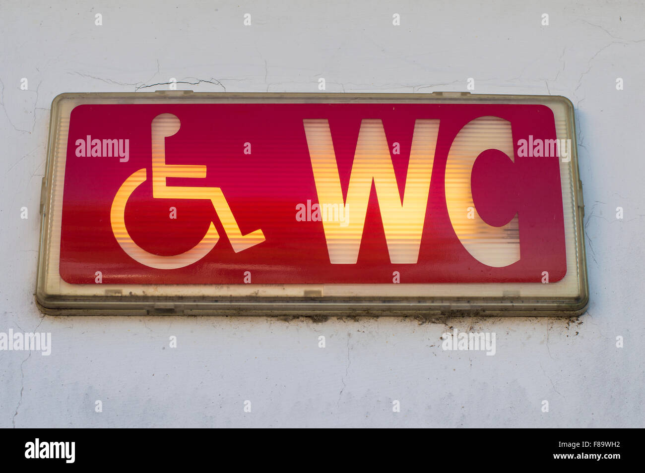 Handicap restroom illuminated sign Stock Photo