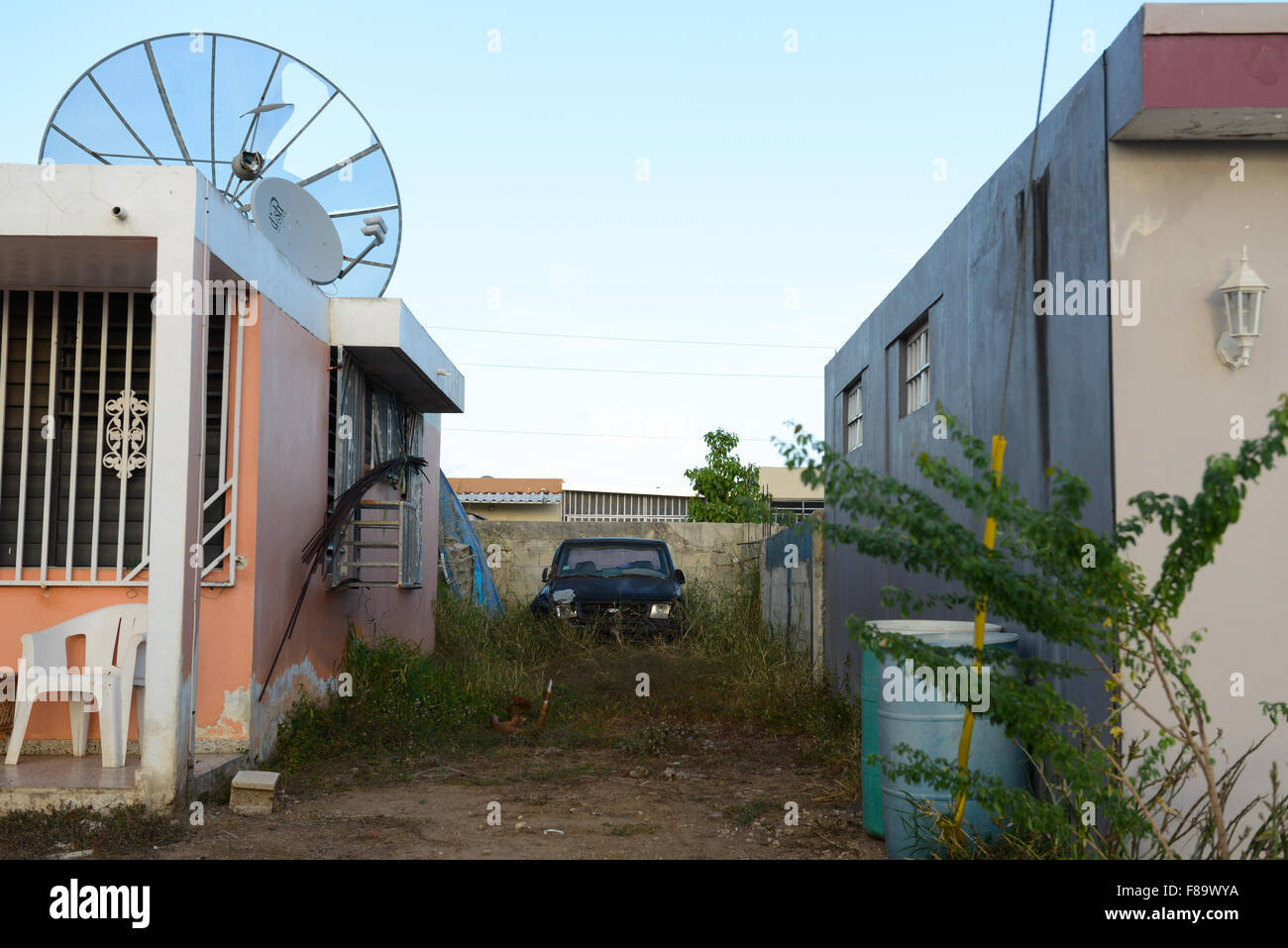 Clunker car abandoned in a private home backyard. Juana Diaz, Puerto Rico. Caribbean Island. USA territory. Stock Photo