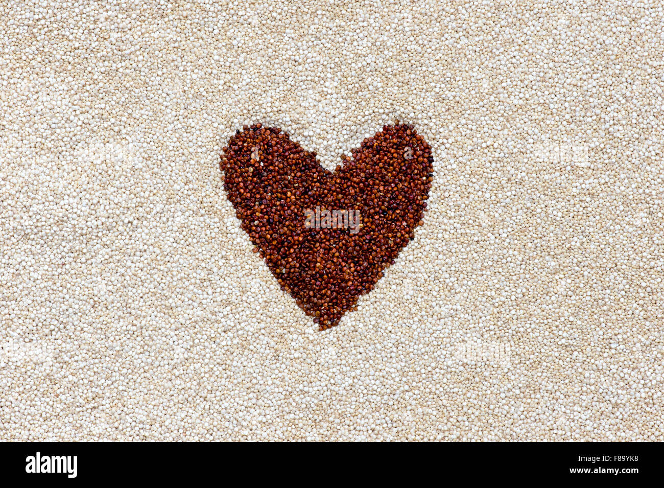 Red Quinoa heart shape in white Quinoa Stock Photo