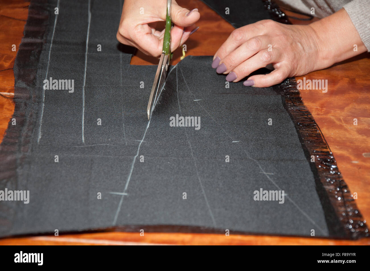 dressmaker at work making patterns of fabric Stock Photo - Alamy