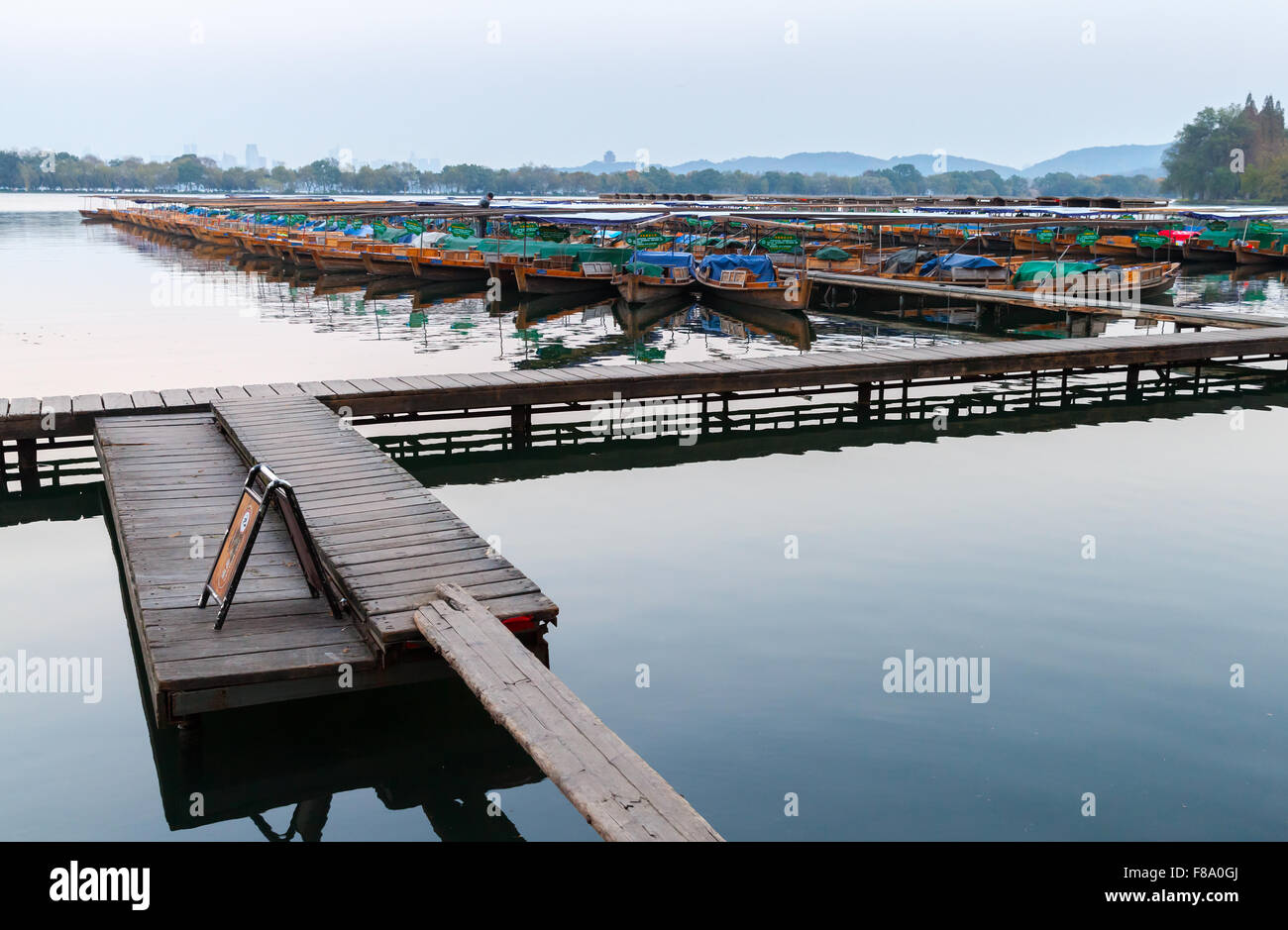 Hangzhou, China - December 4, 2014: Traditional Chinese wooden recreation boats floats moored on the West Lake, famous park in H Stock Photo