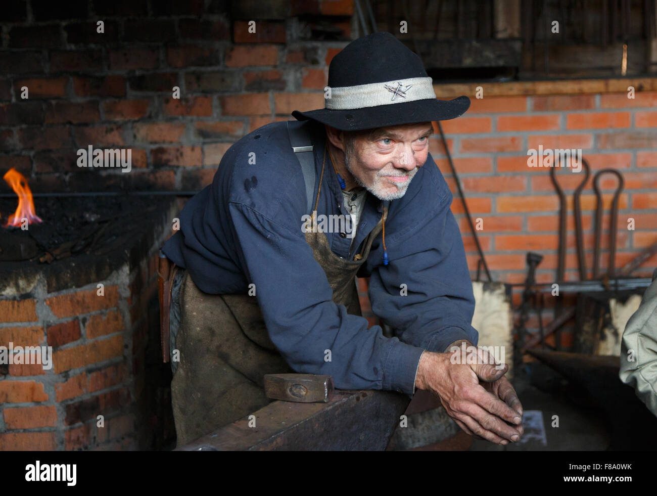 Smith relaxing and looking forward in the forge workshop Stock Photo