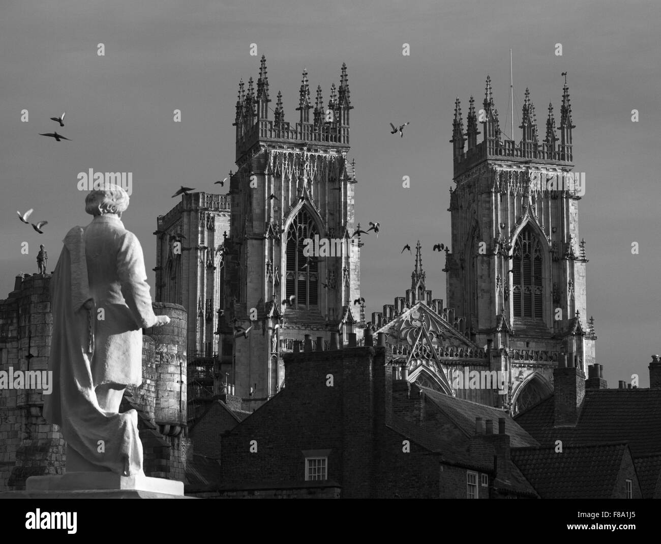 York Minster seen over the rooftops from Exhibition Square with the statue of artist William