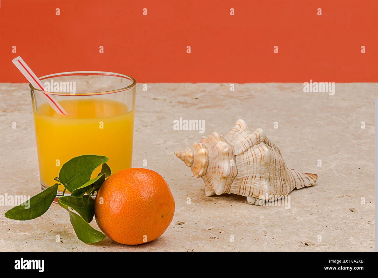 Satsuma orange on natural stone background with glass of orange juice