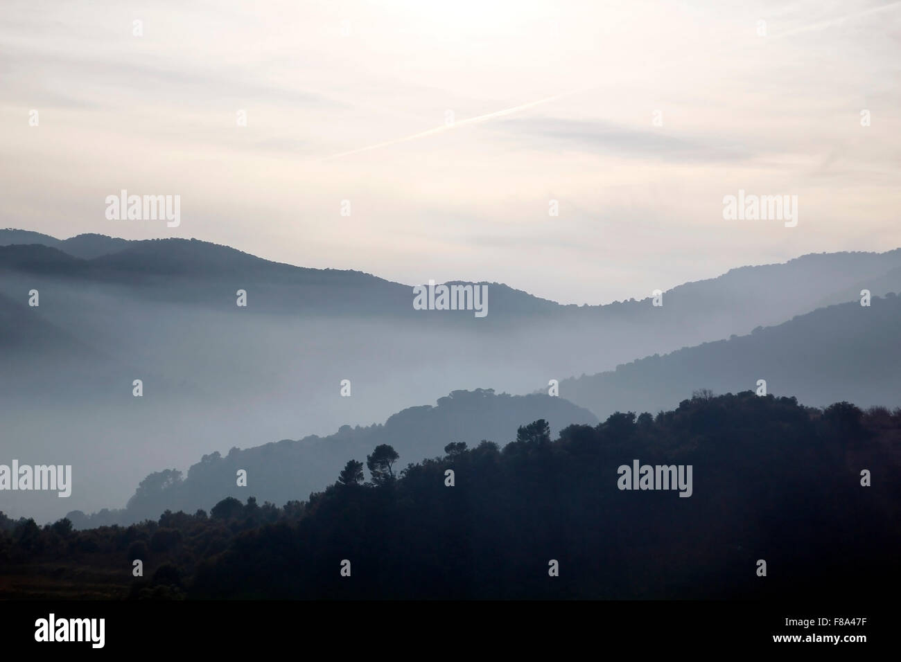 Foggy mountains in a winter morning Stock Photo - Alamy