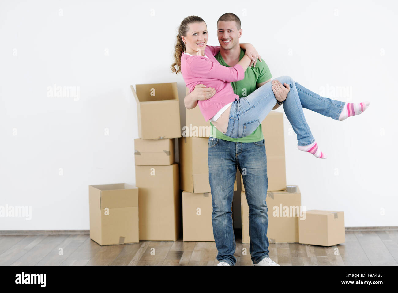 happy Young couple moving in new home Stock Photo - Alamy