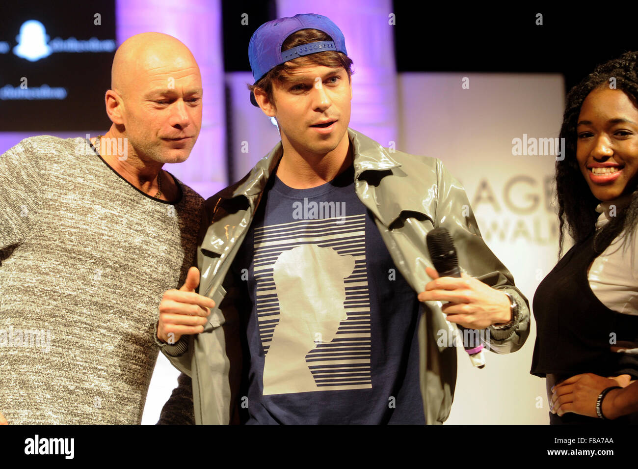 Joey Essex on the catwalk with two audience members at Clothes Show Live, NEC, Birmingham, UK, 7th December 2015. Joey wears items from his own Fusey fashion range. Credit:  Antony Nettle/Alamy Live News Stock Photo