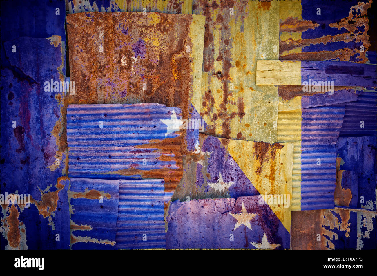 An abstract background image of the flag of Bosnia and Herzegovina painted on to rusty corrugated iron sheets Stock Photo