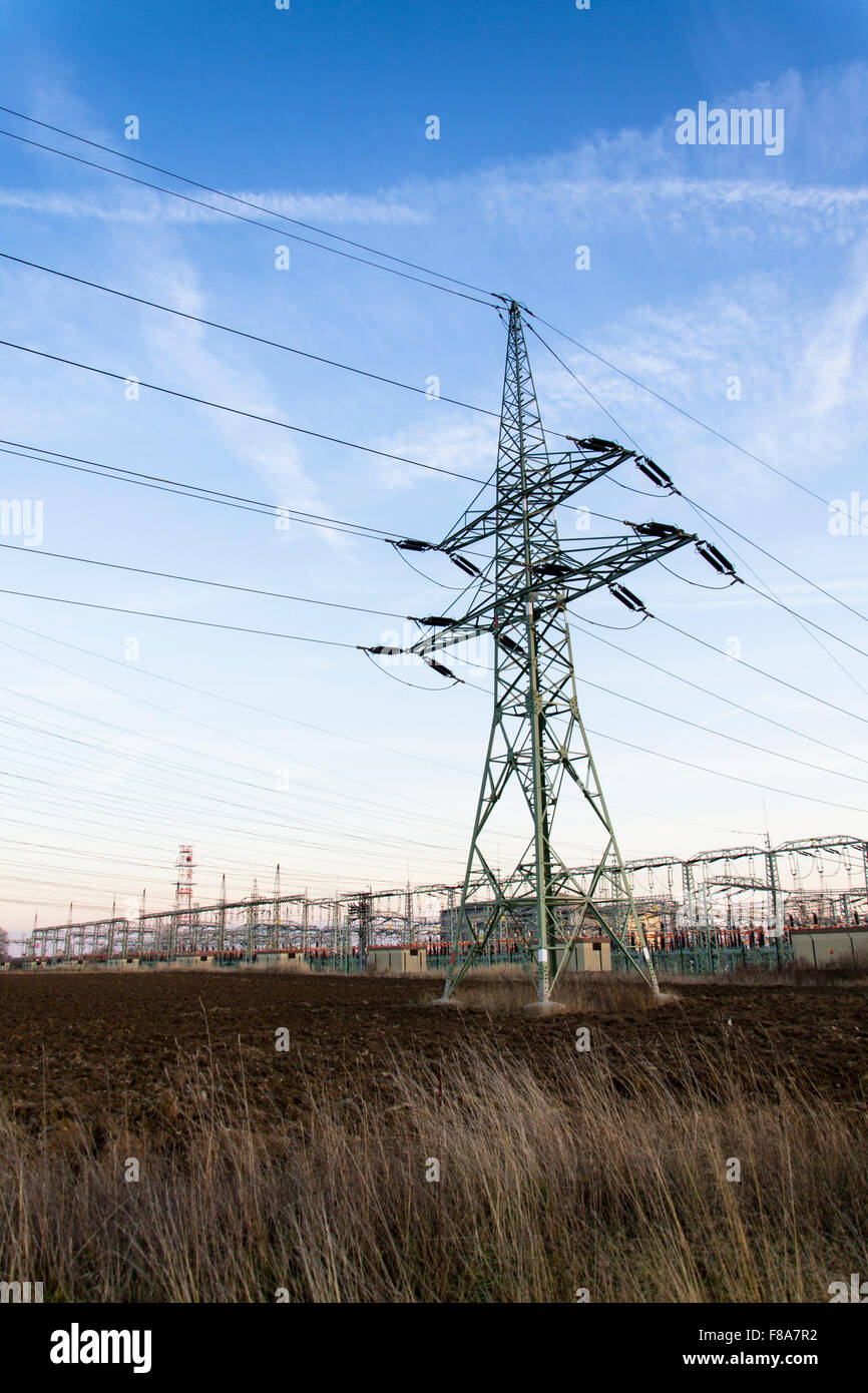 Electricity pylon with dramatic cloudy sky vertical photo Stock Photo ...