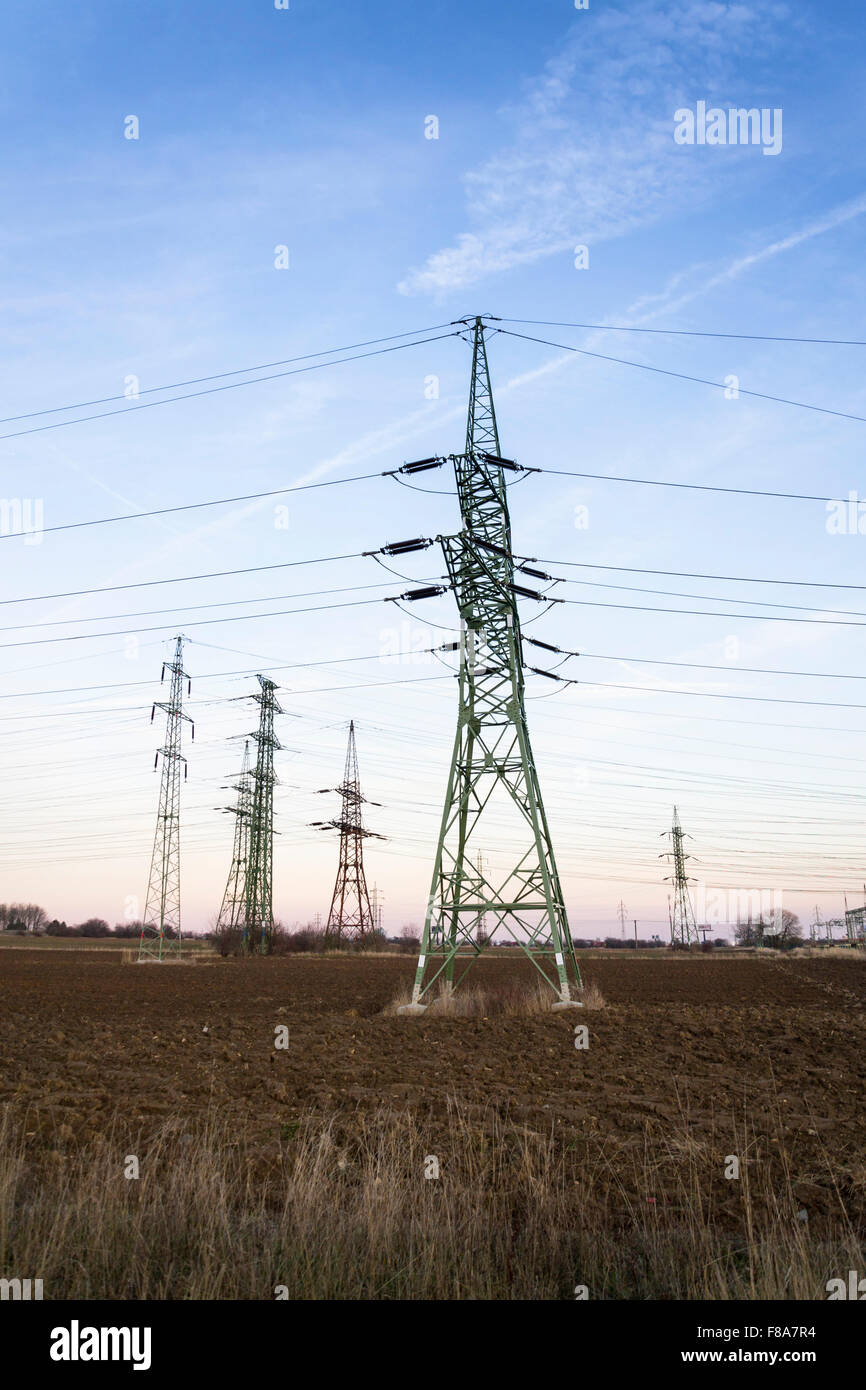 Electricity pylon with dramatic cloudy sky vertical photo Stock Photo ...