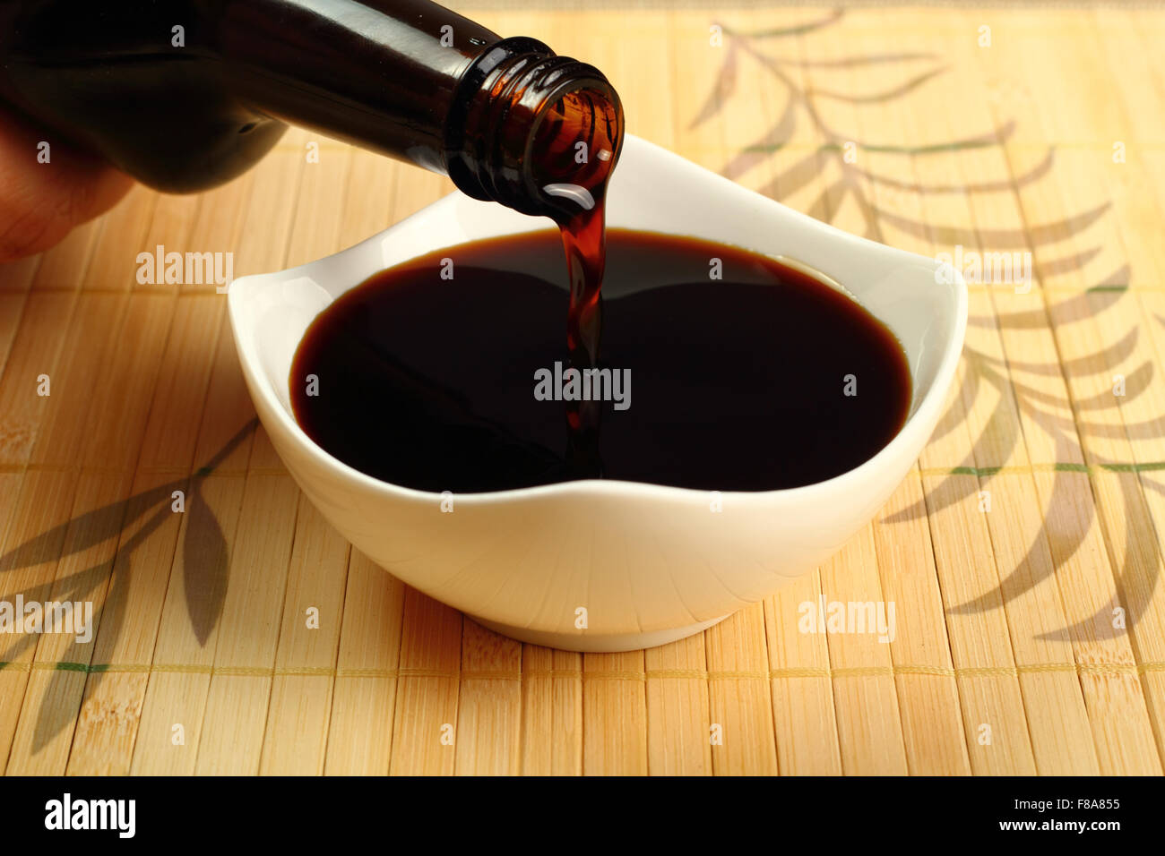 Pouring Soy Sauce into bowl Stock Photo Alamy