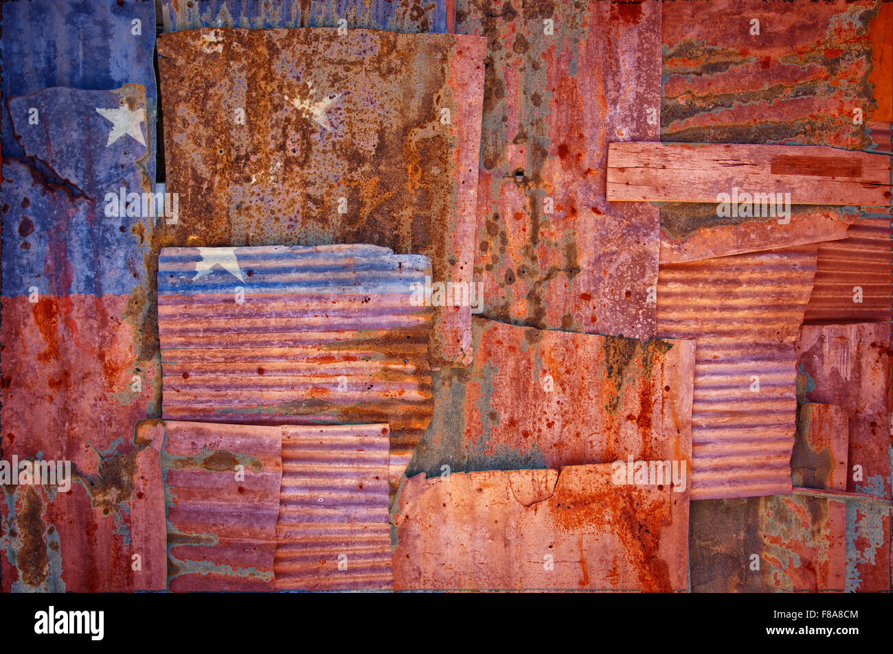 An abstract background image of the flag of Samoa painted on to rusty corrugated iron sheets overlapping to form a wall or fence Stock Photo