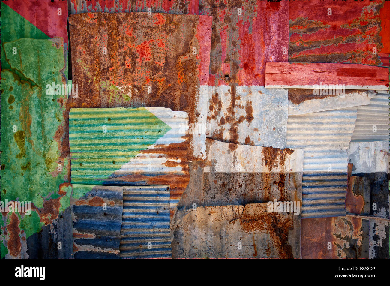 An abstract background image of the flag of Sudan painted on to rusty corrugated iron sheets overlapping to form a wall or fence Stock Photo