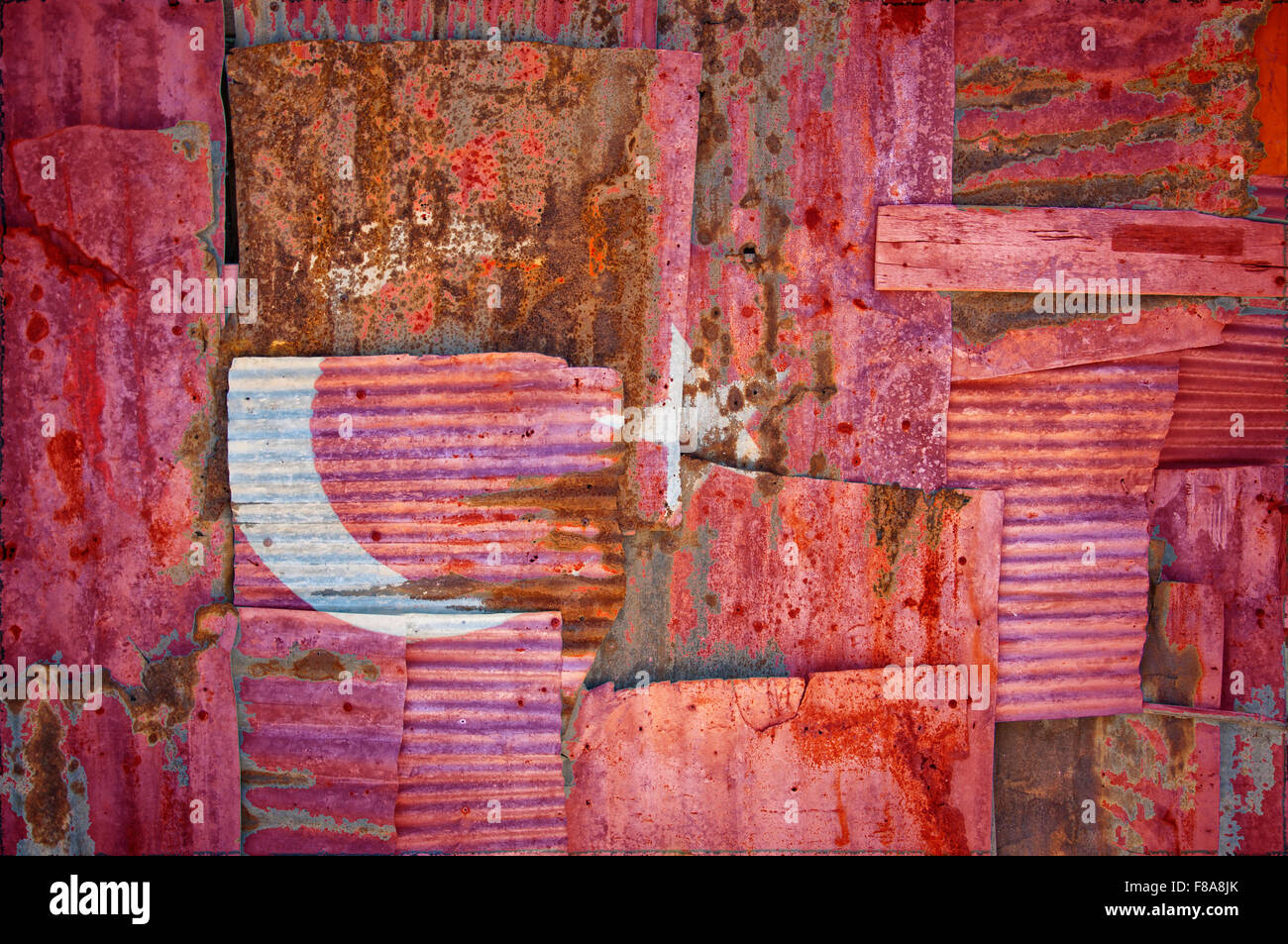 An abstract background image of the flag of Turkey painted on to rusty corrugated iron sheets overlapping to form a wall Stock Photo