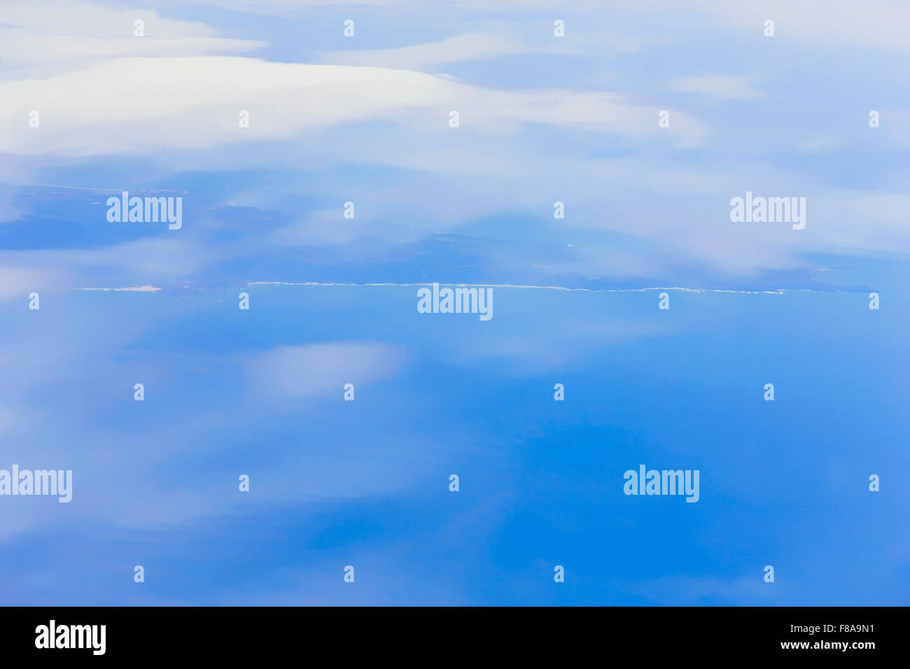 View on blue sky above white clouds and cloudscape from the window of ...