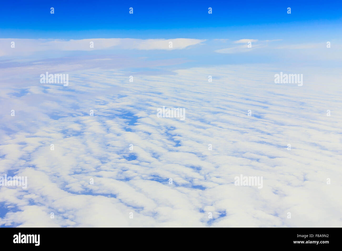 View on blue sky above white clouds from the window of plane Stock ...