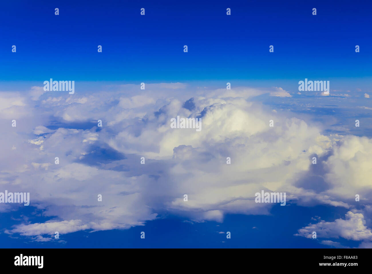 View on blue sky over white clouds from the window of airplane Stock ...
