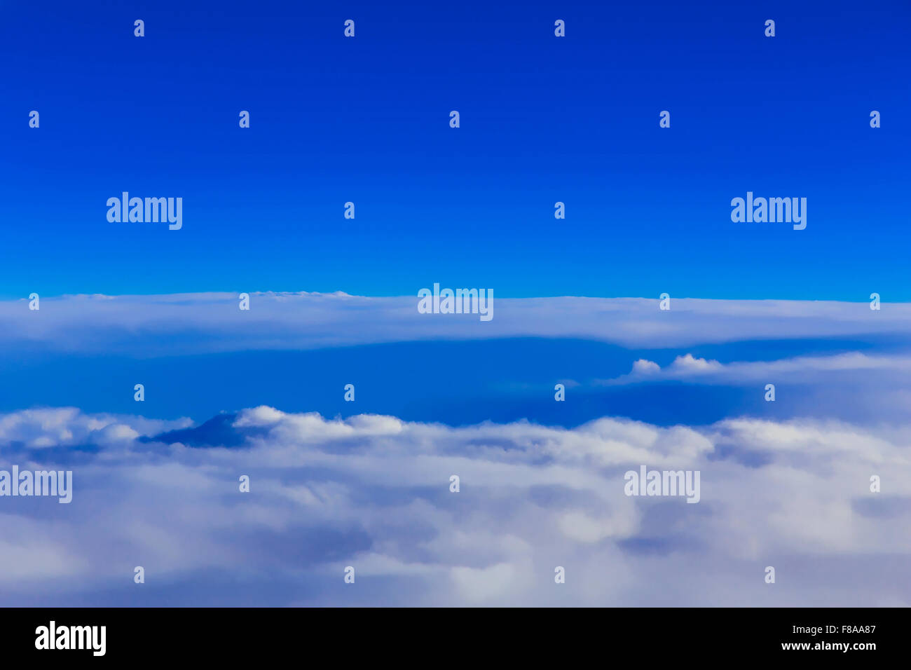View on blue sky over white clouds from the window of airplane Stock ...