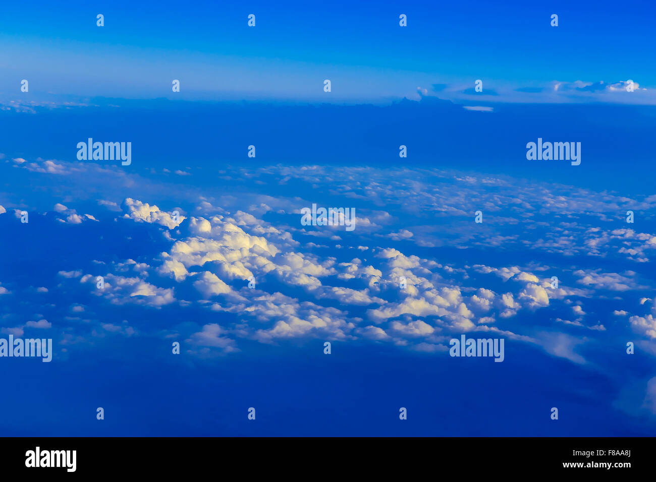 View on blue sky above white clouds from the window of airplane Stock ...