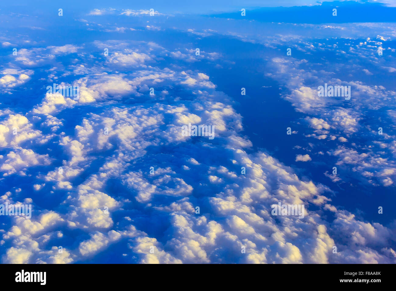 View on blue sky above white clouds and cloudscape from the window of ...