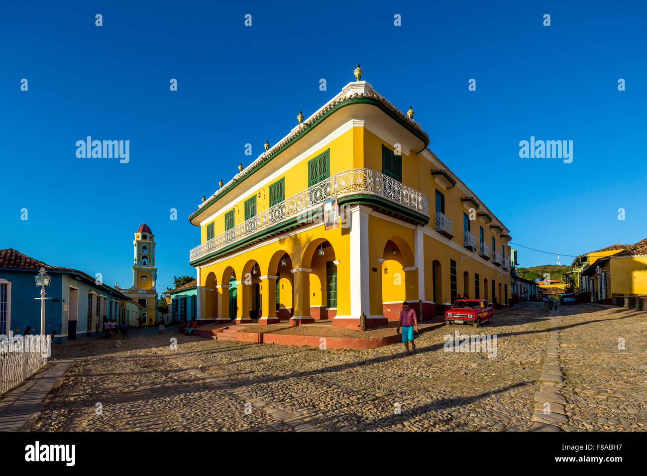 Center of Trinidad Palacio Brunet, yellow palace with blue sky and the church Convento de San Francisco de Asis, Street Scene, Stock Photo