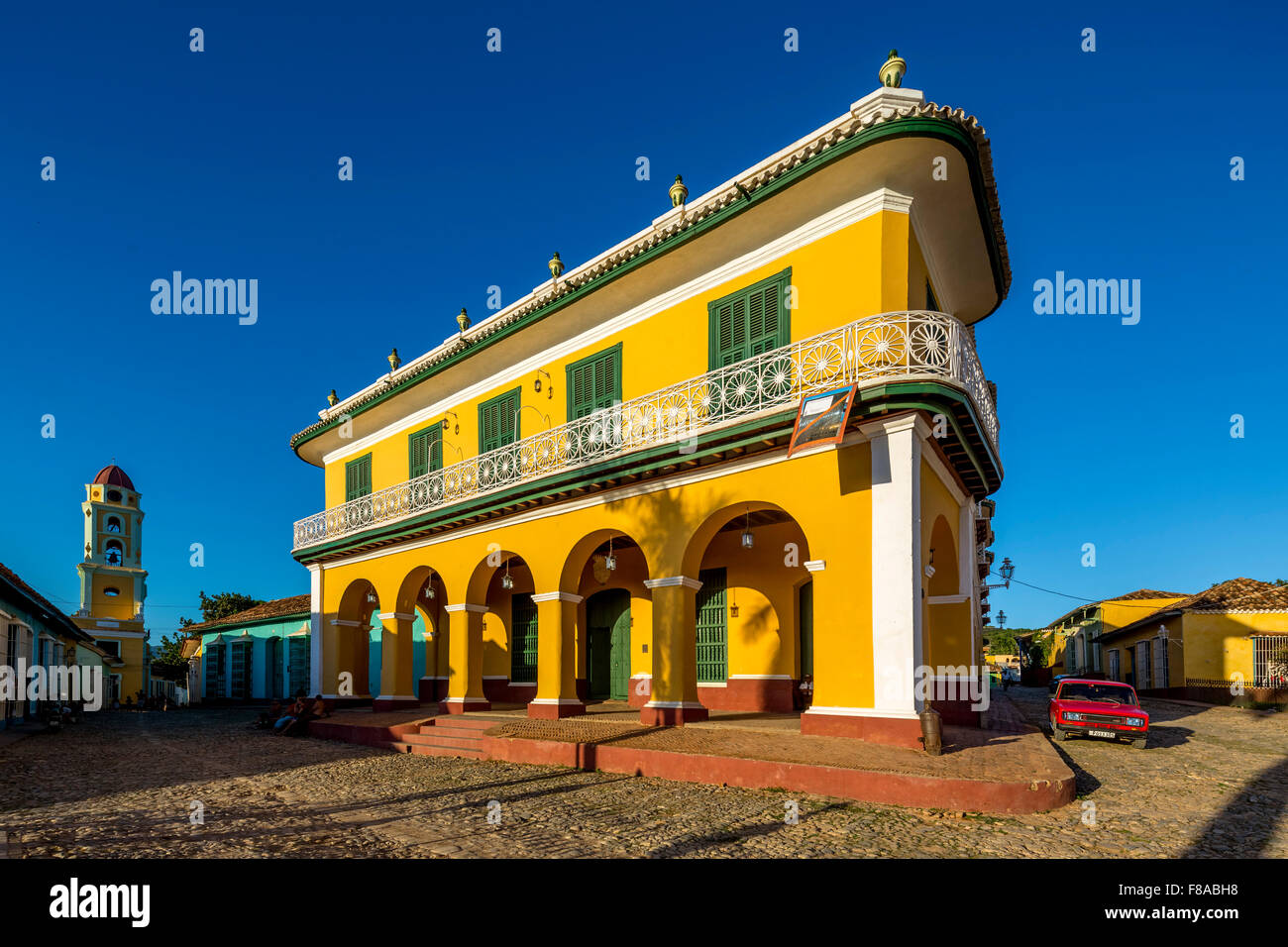 Center of Trinidad Palacio Brunet, yellow palace with blue sky and the church Convento de San Francisco de Asis, Street Scene, Stock Photo