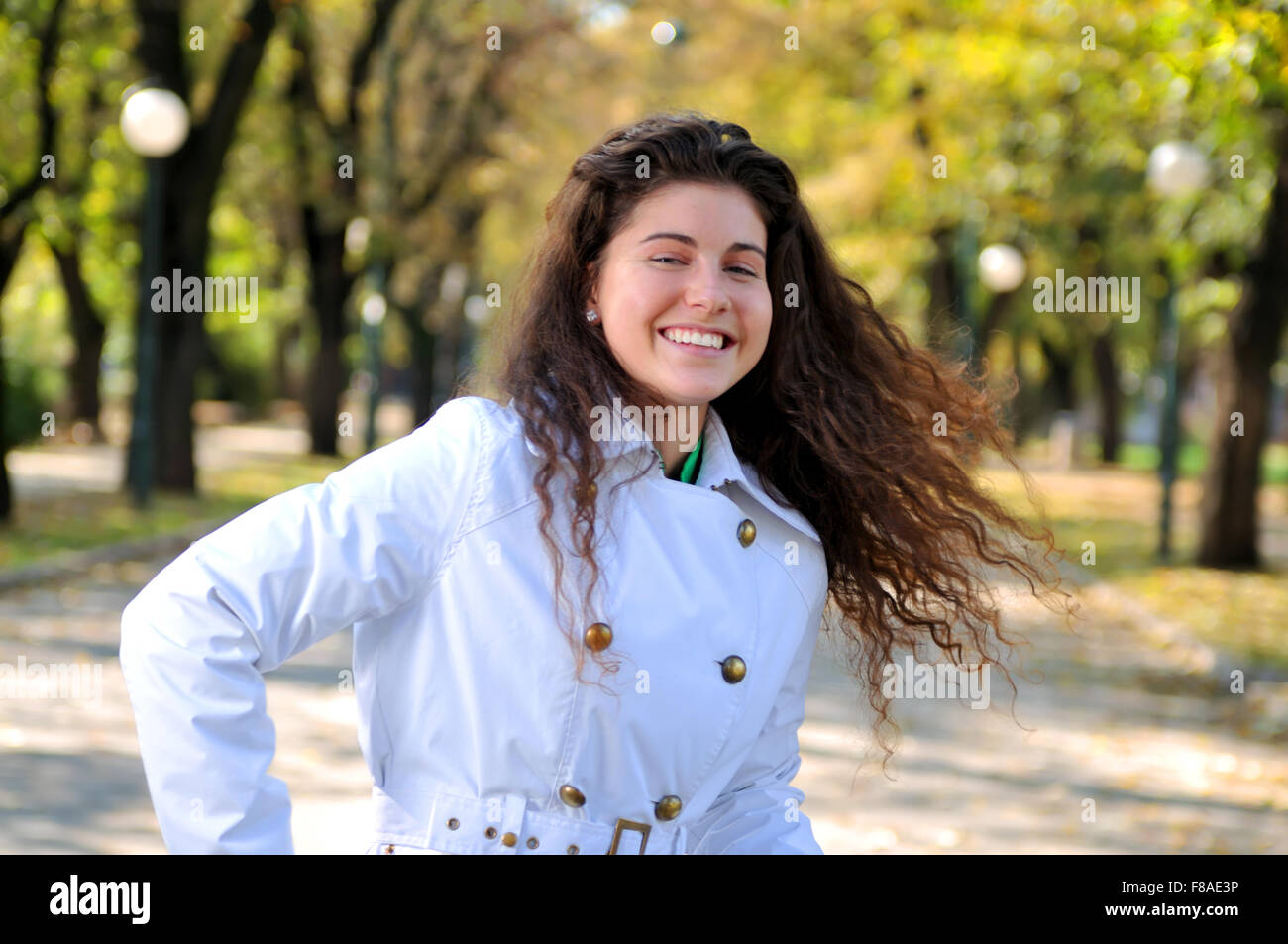 brunette Cute young woman smiling outdoors in nature Stock Photo - Alamy