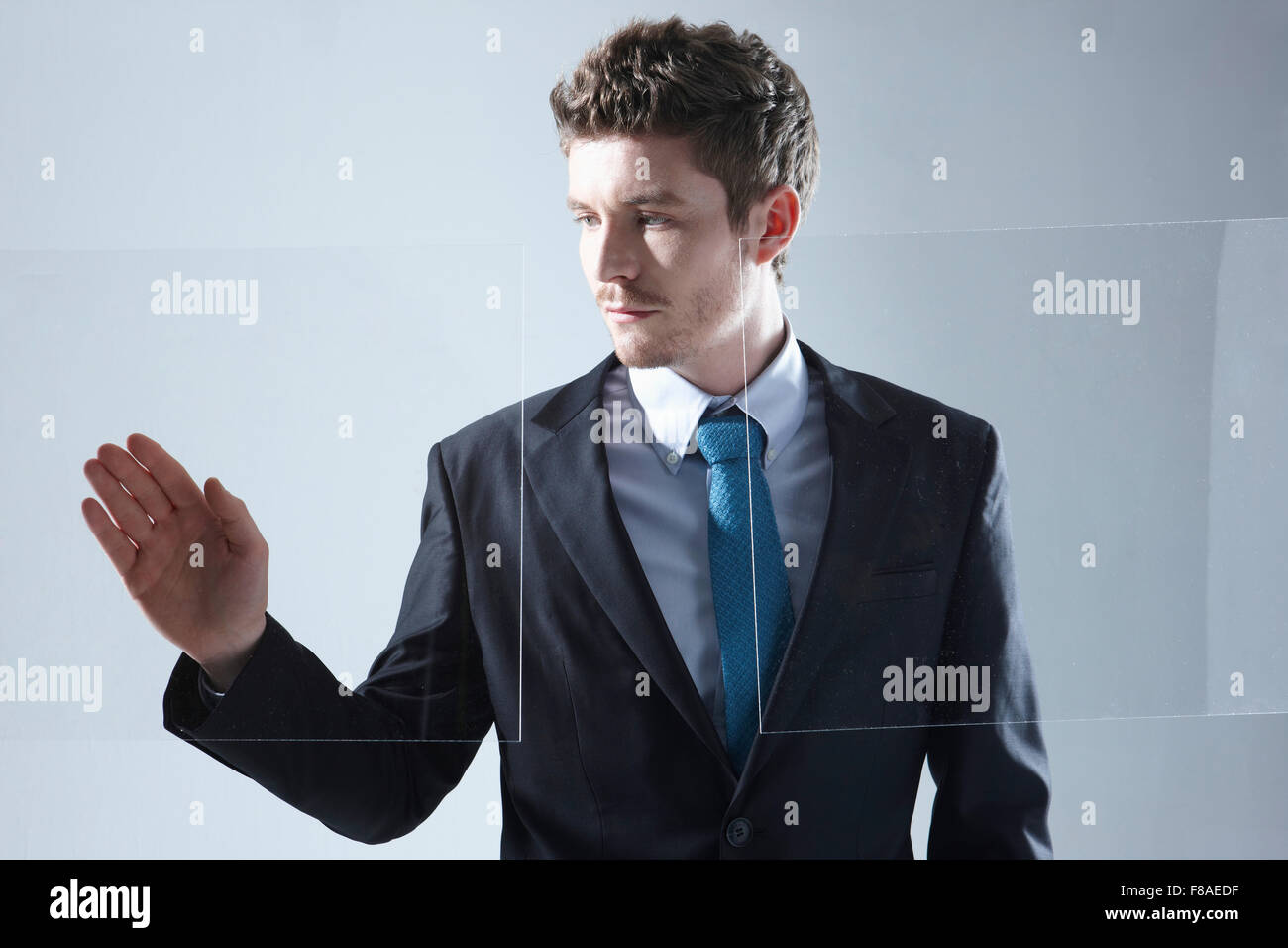 Business man working on touch screen with one hand Stock Photo
