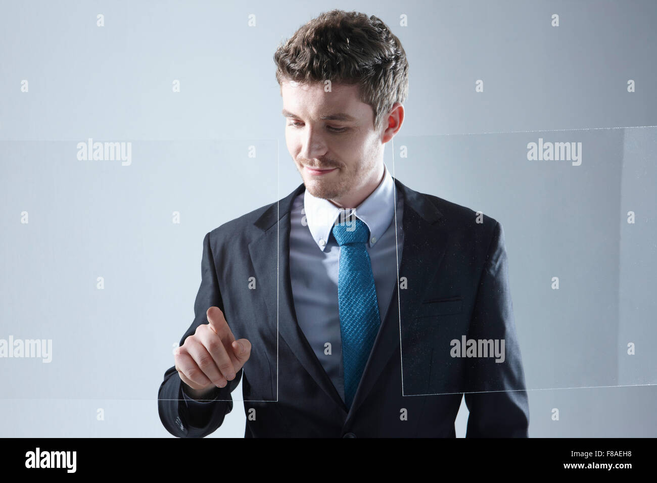 Business man working on a touch screen with one hand Stock Photo
